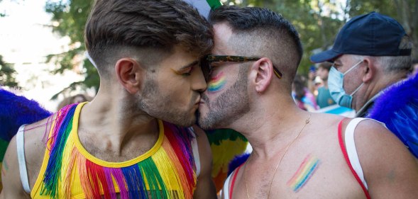 A gay or queer couple kissing