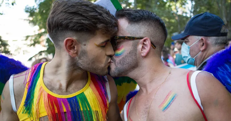 A gay or queer couple kissing