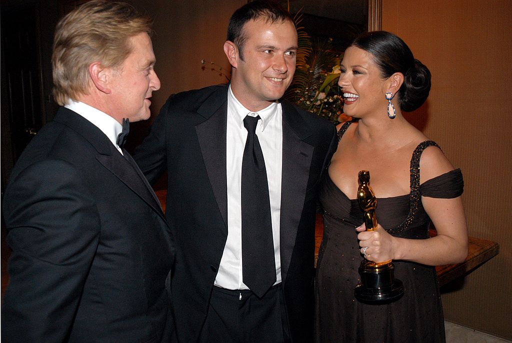 Catherine Zeta-Jones (right) with brother David (centre) and husband Michael Douglas (left)