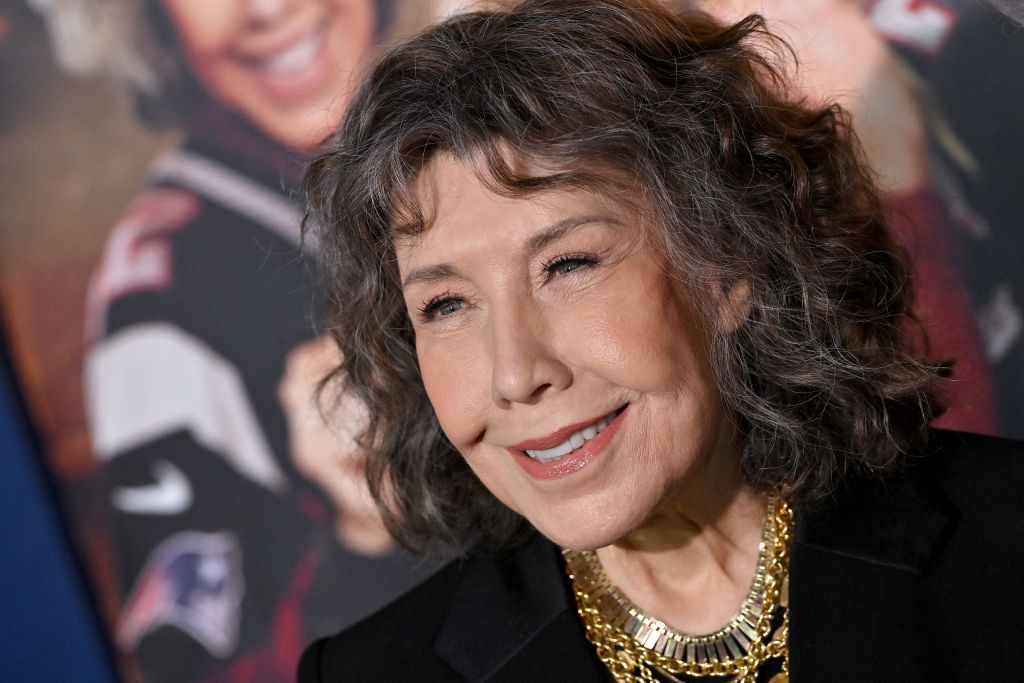 Lily Tomlin in a black jacket and gold necklace