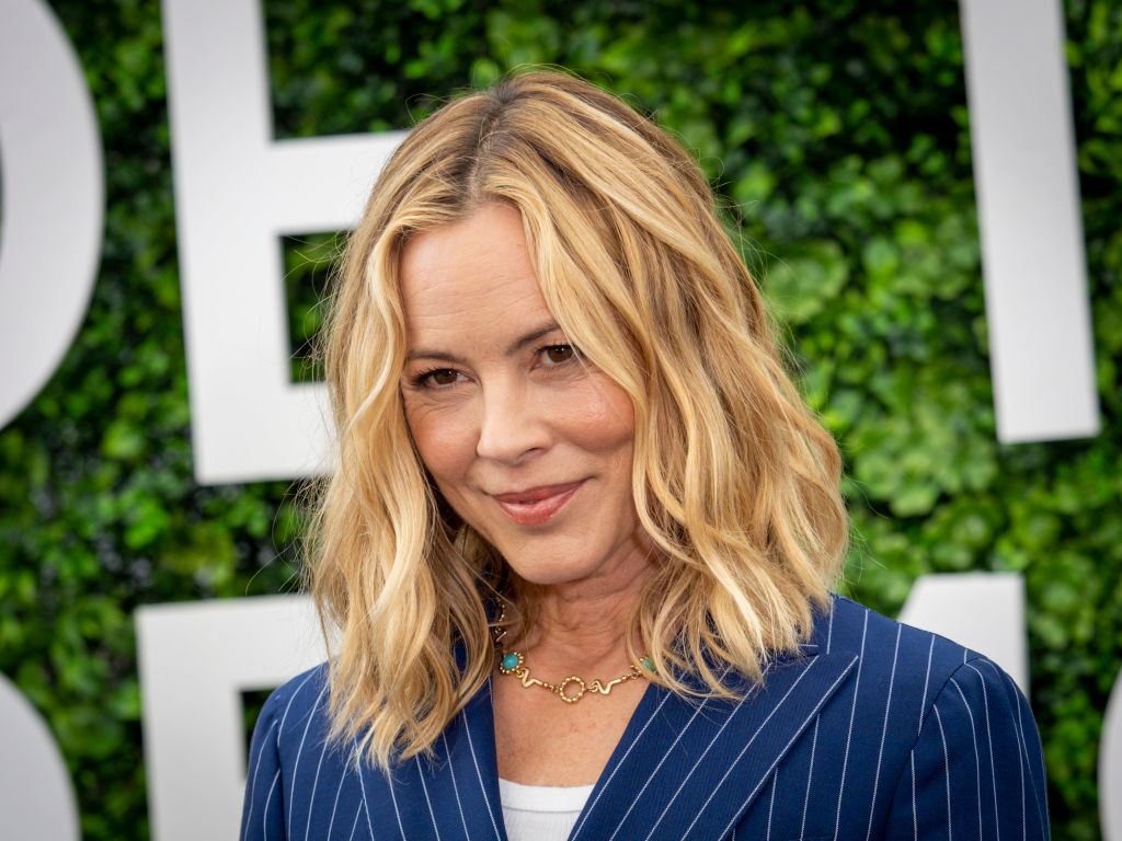 Maria Bello in a blue pinstripe suit jacket