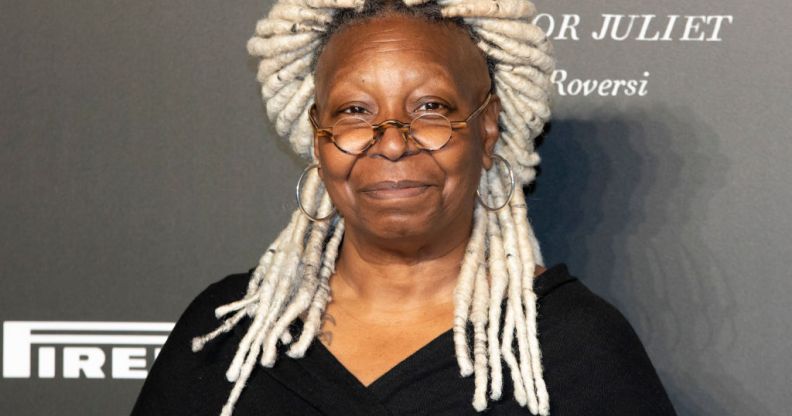 Whoopi Goldberg with blond dreadlocks wearing a black dress