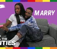 This is an image of two Black men sitting on a couch with a purple background behind them. In text reads "Ask the Aunties" and "Marry Me!"