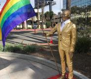 Photo of the Kevin Hart statue holding a rainbow flag.