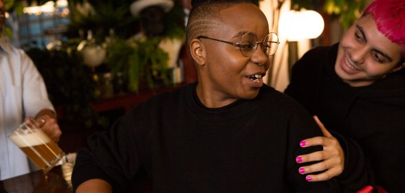 A transmasculine person with a friend at the bar. (The Gender Spectrum Collection/Broadly)