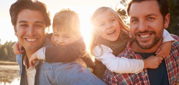 A gay male couple representing same-sex couples who have a child through an adoption agency