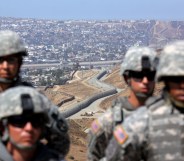 National Guardsmen stand in formation along the U.S.-Mexico border during a visit by California Gov. Arnold Schwarzenegger August 18, 2010 in San Ysidro, California.
