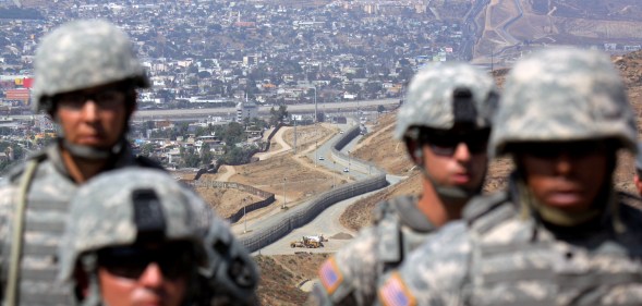 National Guardsmen stand in formation along the U.S.-Mexico border during a visit by California Gov. Arnold Schwarzenegger August 18, 2010 in San Ysidro, California.