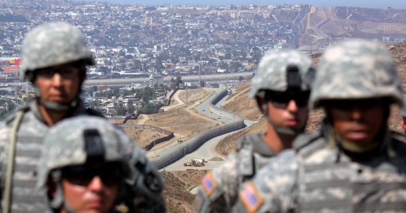 National Guardsmen stand in formation along the U.S.-Mexico border during a visit by California Gov. Arnold Schwarzenegger August 18, 2010 in San Ysidro, California.