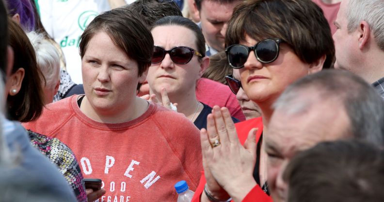 Sara Canning (L), partner of killed journalist Lyra McKee, stands beside Democratic Unionist Party (DUP) leader Arlene Foster (R) at a gathering to condemn McKee's killing near the scene of rioting violence in the Creggan area of Derry in Northern Ireland