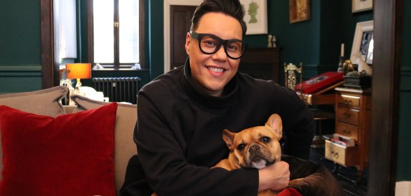 Gay TV presenter Gok Wan at home with his dog