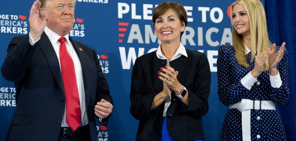 Iowa Governor Kim Reynolds (C) pictured between President Donald Trump (L) and his daughter Ivanka Trump (R), as he holds a roundtable discussion on workforce development at Northeast Iowa Community College in Peosta, Iowa, July 26, 2018.