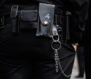 A utility belt and keychain is seen on a prison guard.