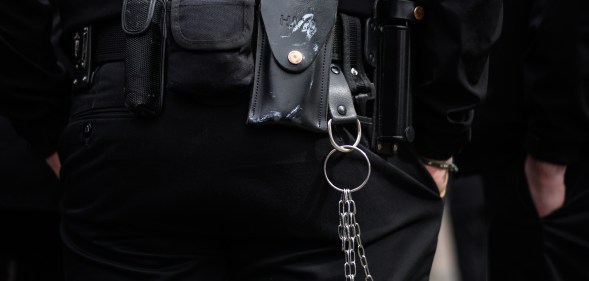 A utility belt and keychain is seen on a prison guard.