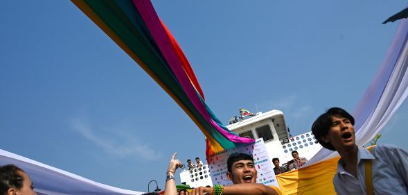 Members of the lesbian, gay, bisexual, and transgender (LGBT) community dance and take selfies under rainbow flags displayed on a boat during the Pride Boat Parade, an event of the Myanmar's Yangon Pride festival in Yangon on January 26, 2019.