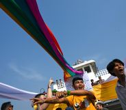 Members of the lesbian, gay, bisexual, and transgender (LGBT) community dance and take selfies under rainbow flags displayed on a boat during the Pride Boat Parade, an event of the Myanmar's Yangon Pride festival in Yangon on January 26, 2019.