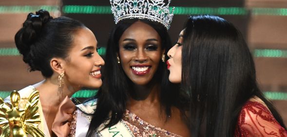 Jazell Barbie Royale (C) of the US, the Miss International Queen 2019 receives a kiss from finalists Kanwara Kaewjin (L) of Thailand and Yaya (R) of China