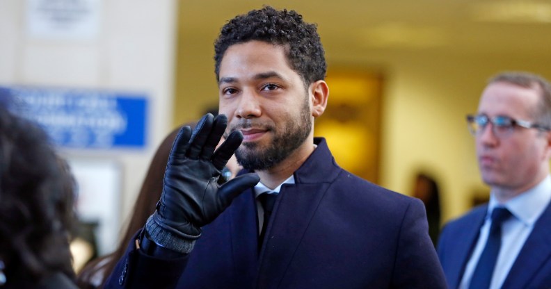 Actor Jussie Smollett waves as he follows his attorney to the microphones after his court appearance at Leighton Courthouse on March 26, 2019 in Chicago, Illinois.