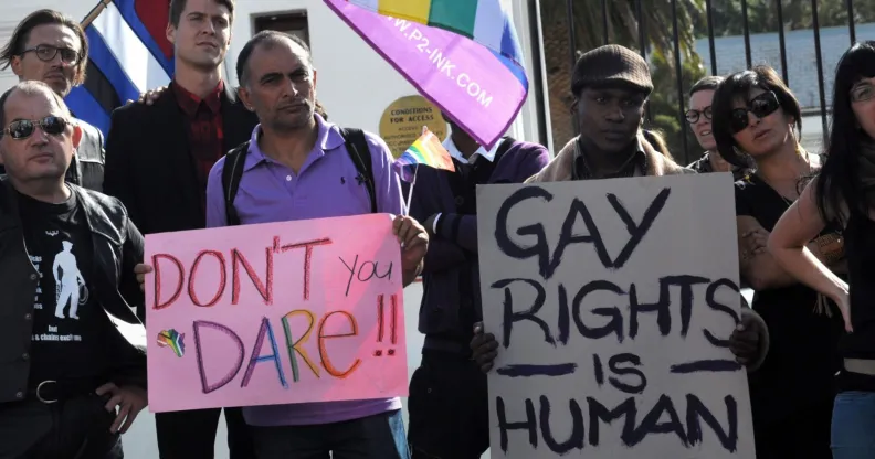 A group of people from the gay, lesbian and transgender community in South Africa demonstrate outside the Parliament in Cape Town, on May 19, 2012. The protesters gathered to oppose the proposal by the House of Traditional Leaders to remove the term "sexual orientation" from section 9 (3) of the South African Constitution, which prohibits unfair discrimination. AFP PHOTO / RODGER BOSCH (Photo credit should read RODGER BOSCH/AFP/GettyImages)