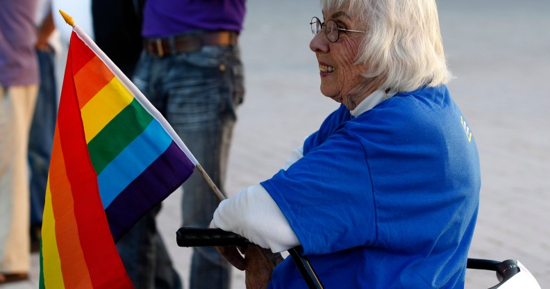 Older LGBT people like this woman holding a gay pride flag at a same-sex marriage victory celebration remain to be met.