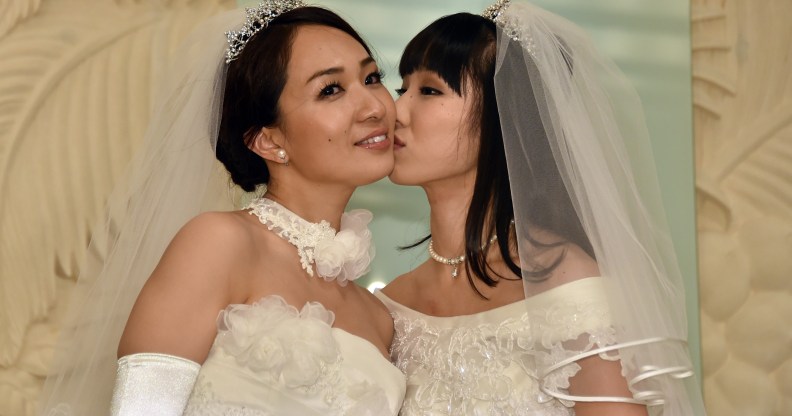 Japanese actress Akane Sugimori (R) kisses her partner Ayaka Ichinose in a 2015 protest for marriage equality, for which 13 gay couples are now suing the government on Valentine's Day.