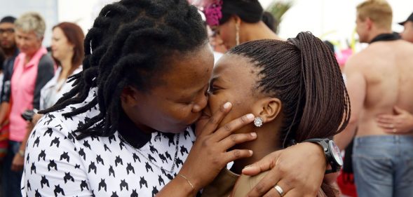 A couple kiss as members of the South African Lesbian, Gay, Bisexual and Transgender (LGBT) community take part in the annual Gay Pride Parade at Durban's North Beach as part of the three-day Durban Pride Festival in Durban on June 27, 2015. AFP PHOTO / RAJESH JANTILAL (Photo credit should read RAJESH JANTILAL/AFP/Getty Images)
