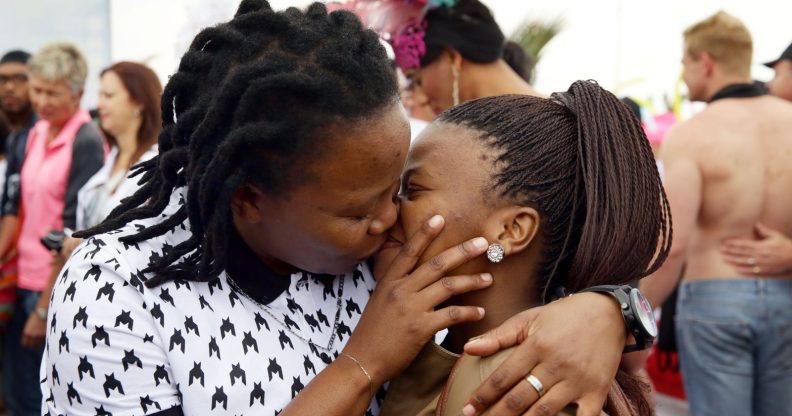 A couple kiss as members of the South African Lesbian, Gay, Bisexual and Transgender (LGBT) community take part in the annual Gay Pride Parade at Durban's North Beach as part of the three-day Durban Pride Festival in Durban on June 27, 2015. AFP PHOTO / RAJESH JANTILAL (Photo credit should read RAJESH JANTILAL/AFP/Getty Images)