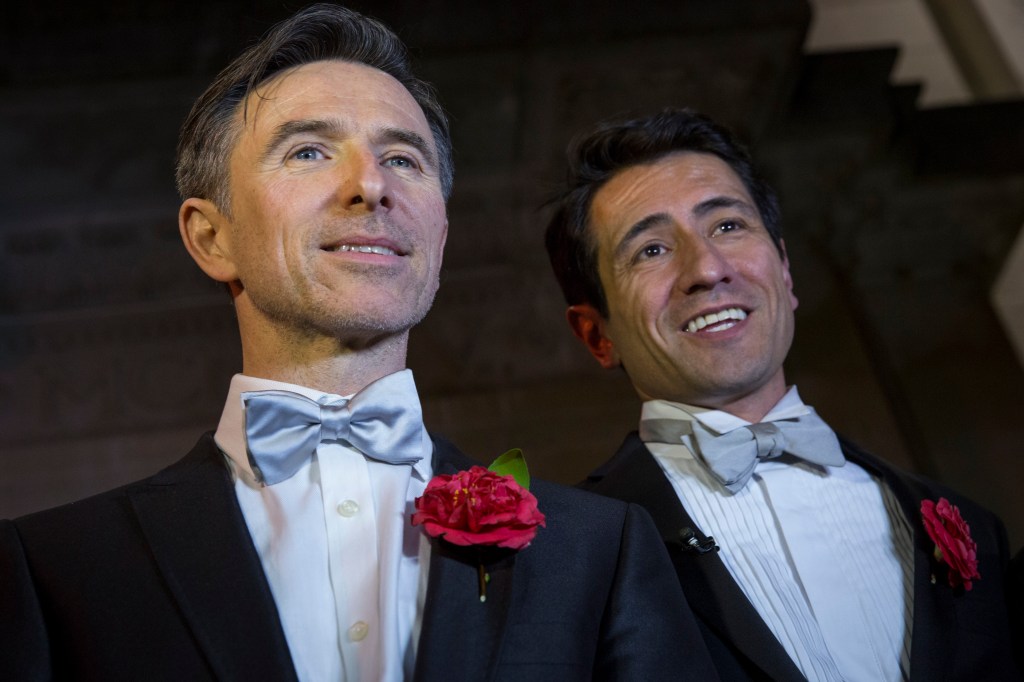 Peter McGraith and David Cabreza speak to well-wishers after being married shortly after midnight at Islington Town Hall in the UK's first same-sex marriage on March 29, 2014 in London, England.