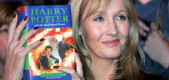JK Rowling holds Harry Potter book