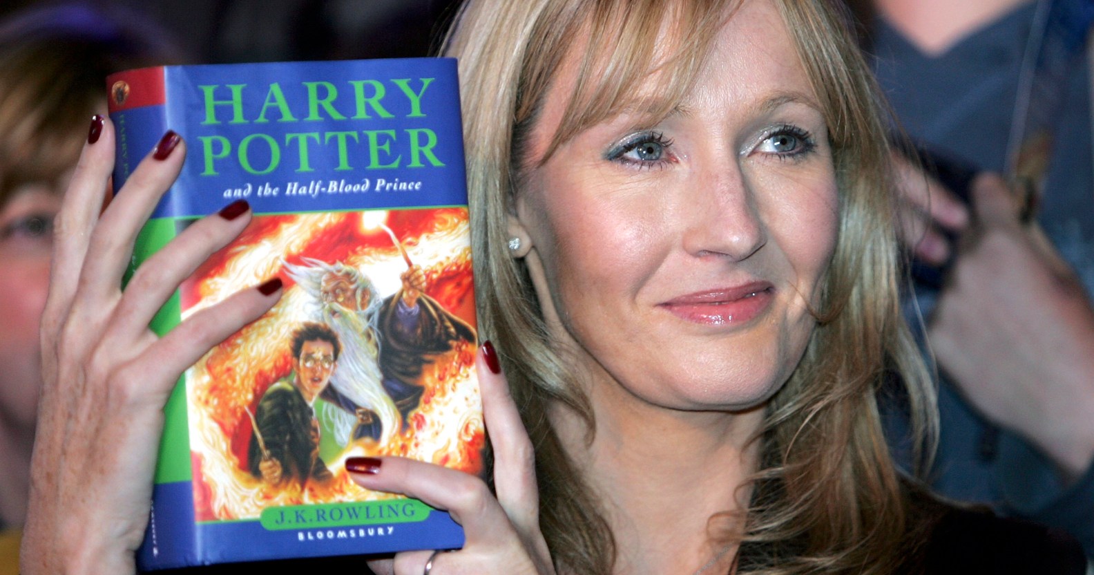 JK Rowling holds Harry Potter book