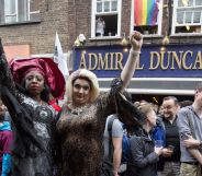 Photo of people gathering outside the Admiral Duncan pub in Old Compton Street in the Soho, which was attacked with a nail bomb on April 30, 1999, to remember the victims of the Orlando massacre, on June 13, 2016.