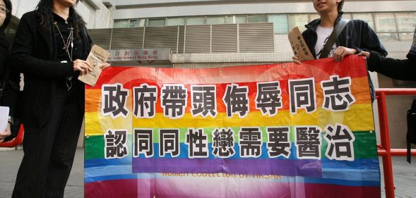Hong Kong, CHINA: A gay and homosexual group lead a protest to government offices in Hong Kong 01 December 2006. The group were urging the government to end discrimination to homosexuals with regard to an organisation which promotes conversion therapy for homosexuals. Banner reads" Government leads campaign to insult gays and believes they need a cure" AFP PHOTO/MIKE CLARKE (Photo credit should read MIKE CLARKE/AFP/Getty Images)