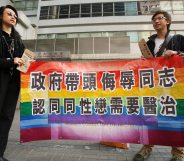 Hong Kong, CHINA: A gay and homosexual group lead a protest to government offices in Hong Kong 01 December 2006. The group were urging the government to end discrimination to homosexuals with regard to an organisation which promotes conversion therapy for homosexuals. Banner reads" Government leads campaign to insult gays and believes they need a cure" AFP PHOTO/MIKE CLARKE (Photo credit should read MIKE CLARKE/AFP/Getty Images)