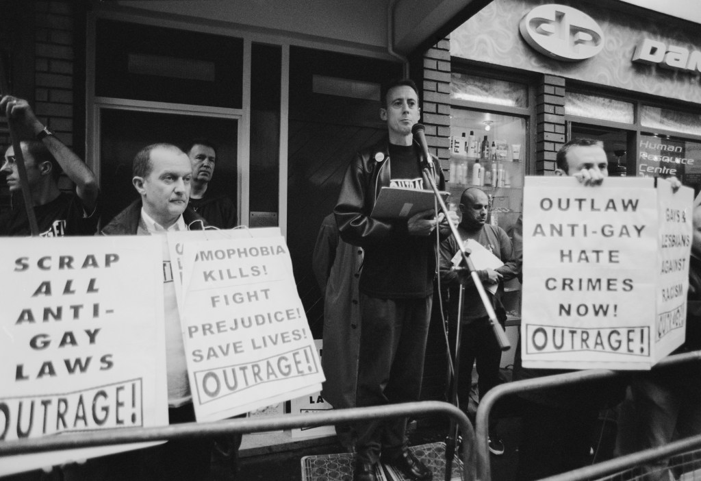 Human rights activist Peter Tatchell (centre) at a vigil organized by the direct action gay rights campaigning group OutRage! in Old Compton Street, Soho, London, 7th May 1999.