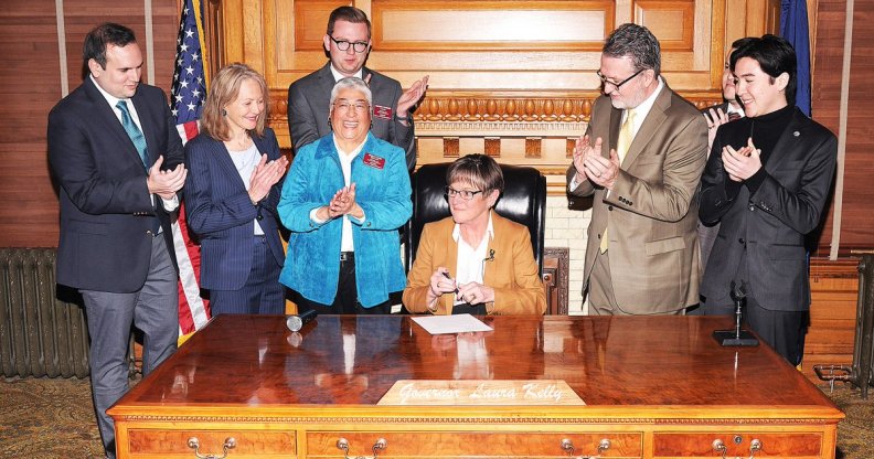 Governor of Kansas Laura Kelly signs an executive order protecting LGBT+ state employees from discrimination