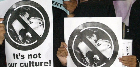 Malaysian Muslim students hold placards during a protest against the US glam rocker Adam Lambert's concert in Bukit Jalil, outside Kuala Lumpur, on October 14, 2010.