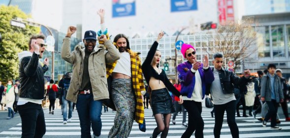 The Queer Eye cast jumping in the middle of a road