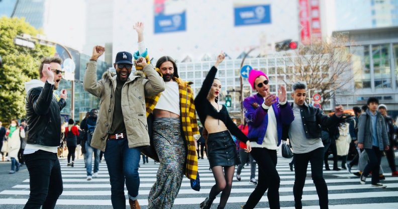 The Queer Eye cast jumping in the middle of a road
