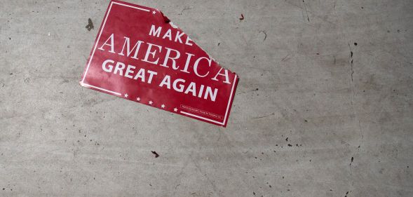 A 'Make America Great Again; sign sits on the floor following a Republicans rally on October 24, 2018.