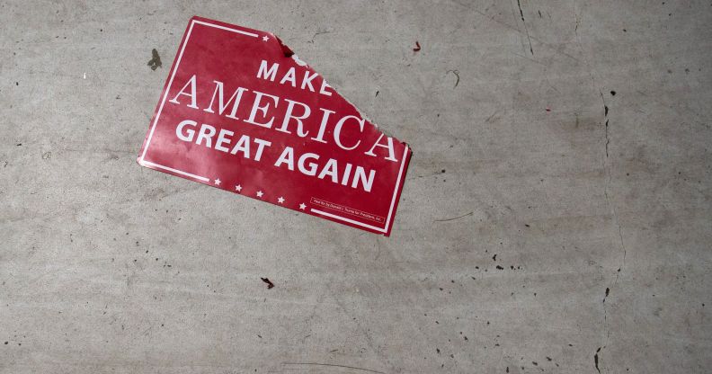 A 'Make America Great Again; sign sits on the floor following a Republicans rally on October 24, 2018.