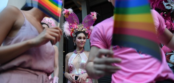 Participants wave rainbow flags during an LGBT+ rights rally in Bangkok, Thailand
