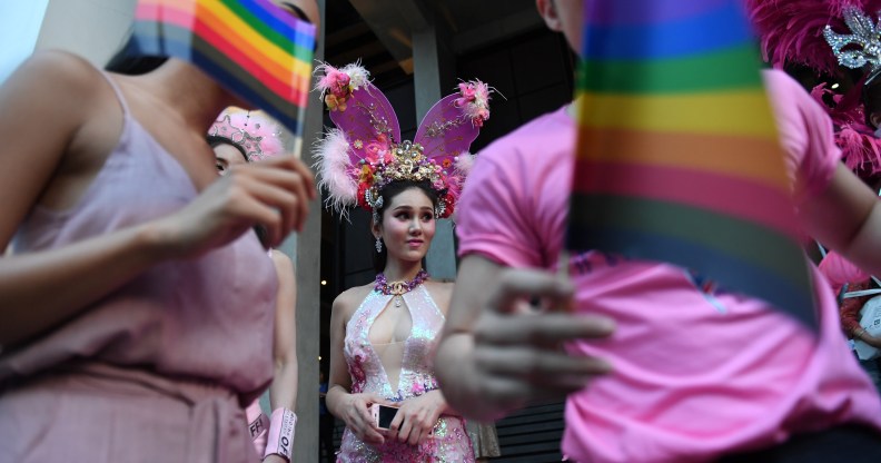 Participants wave rainbow flags during an LGBT+ rights rally in Bangkok, Thailand