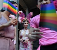 Participants wave rainbow flags during an LGBT+ rights rally in Bangkok, Thailand