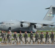 Members of the U.S. Army 173rd Airborne Brigade disembark upon their arrival by plane at a Polish air force base on April 23, 2014 in Swidwin, Poland.
