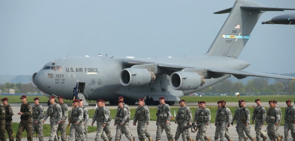 Members of the U.S. Army 173rd Airborne Brigade disembark upon their arrival by plane at a Polish air force base on April 23, 2014 in Swidwin, Poland.