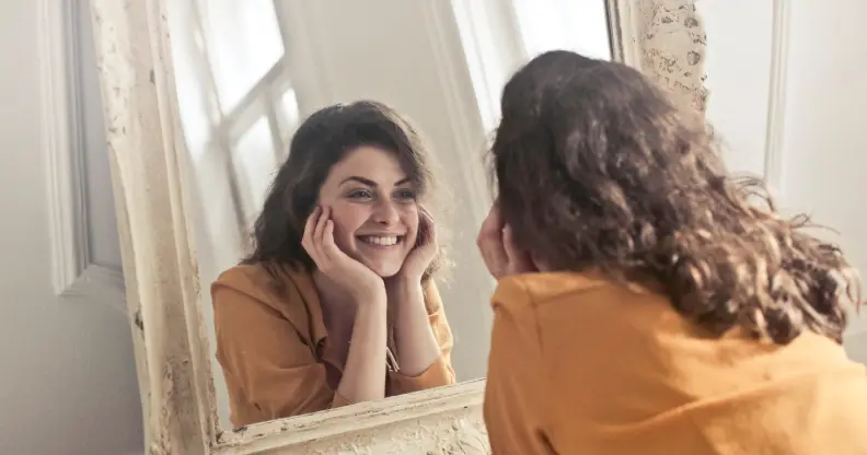 Smiling at reflection in the mirror