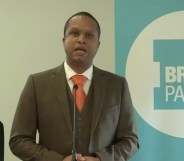 Louis Stedman-Bryce speaking into a microphone