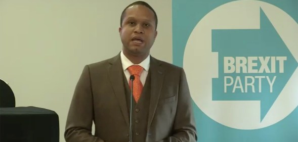 Louis Stedman-Bryce speaking into a microphone