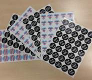 Stickers with messages such as "gender is a spectrum", "respect my pronouns, respect me" and "my pronouns matter"