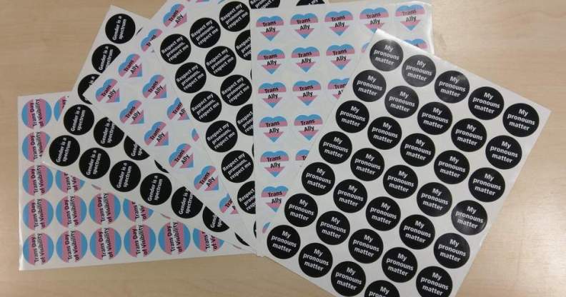 Stickers with messages such as "gender is a spectrum", "respect my pronouns, respect me" and "my pronouns matter"
